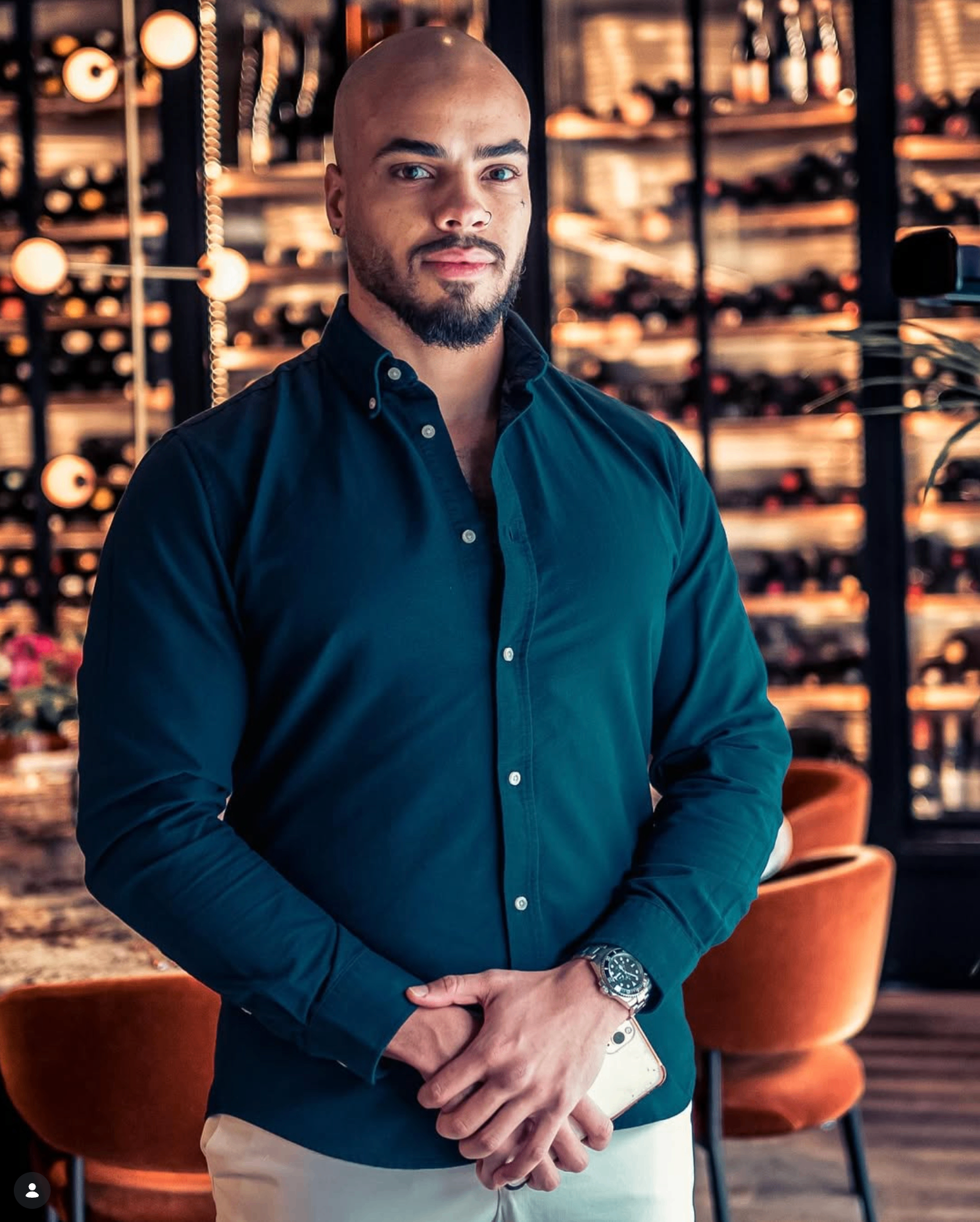 Portrait of Kai Beard in a dark shirt with a luxury interior backdrop