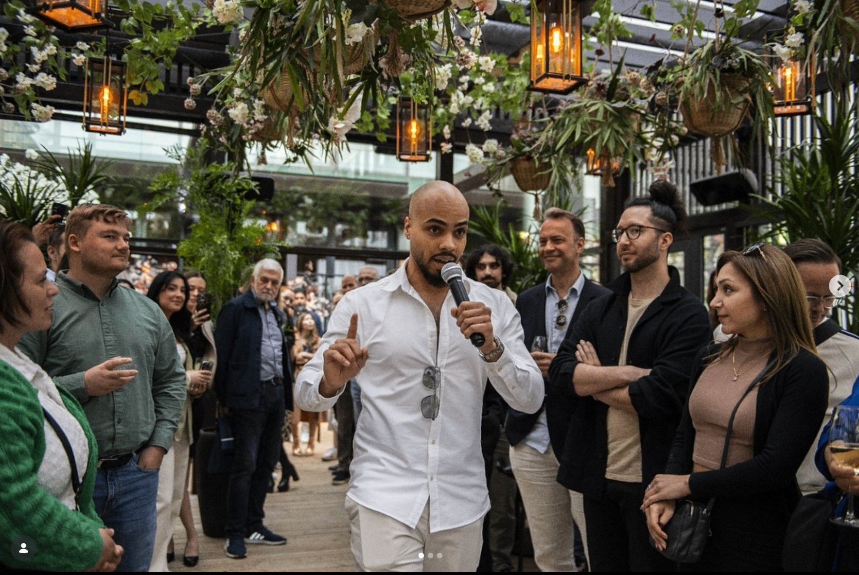 Kai Beard seated in a white blazer, reflecting a polished founder lifestyle